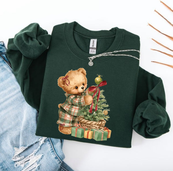 Green sweatshirt with a teddy bear and Christmas tree design on a white background