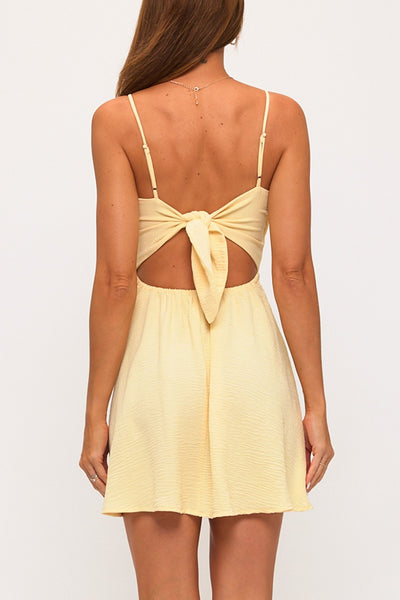 Yellow dress with open back on a white background