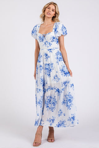 Woman wearing a blue floral dress on a white background