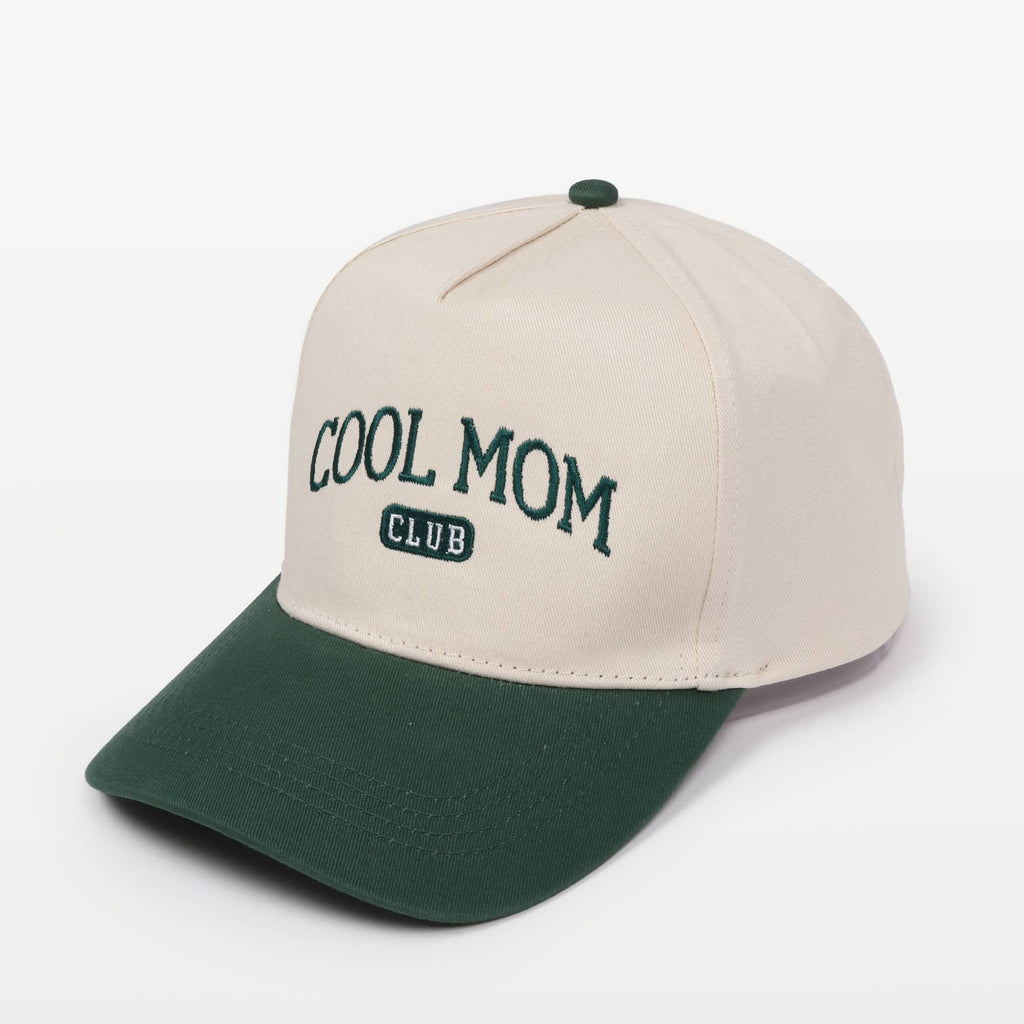 Two-toned baseball cap in cream and green featuring the embroidery "COOL MOM CLUB" against a plain background