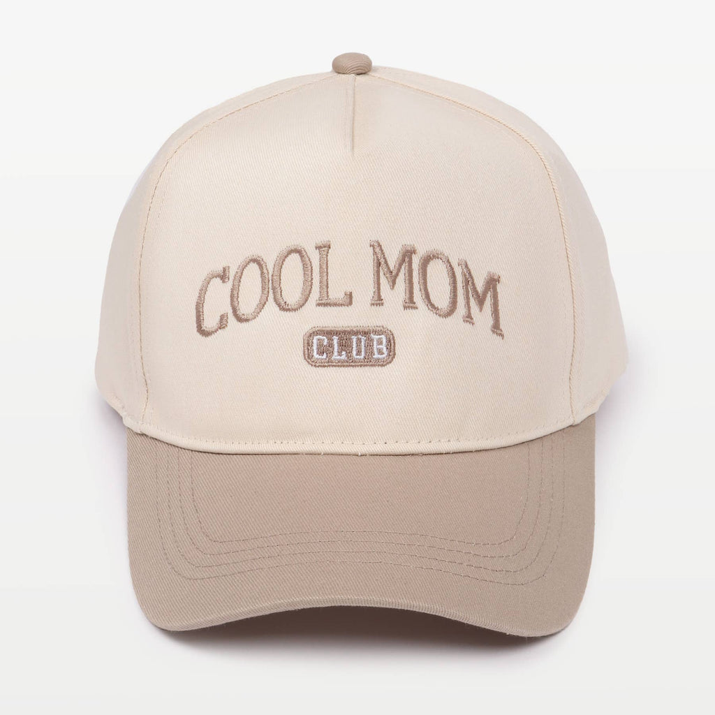 Two-toned baseball cap in cream and beige featuring the embroidery "COOL MOM CLUB" against a plain background