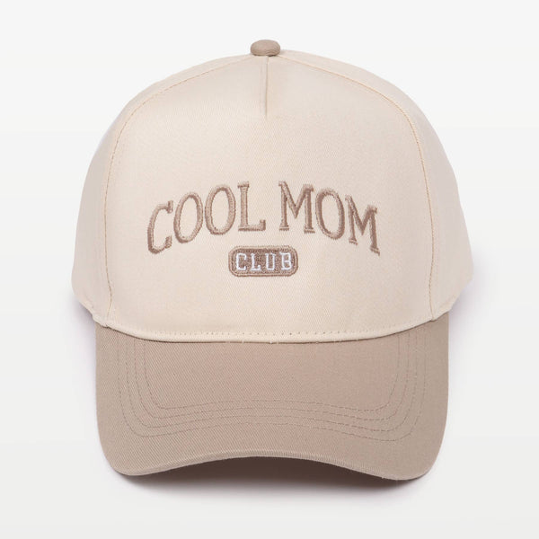 Two-toned baseball cap in cream and beige featuring the embroidery "COOL MOM CLUB" against a plain background
