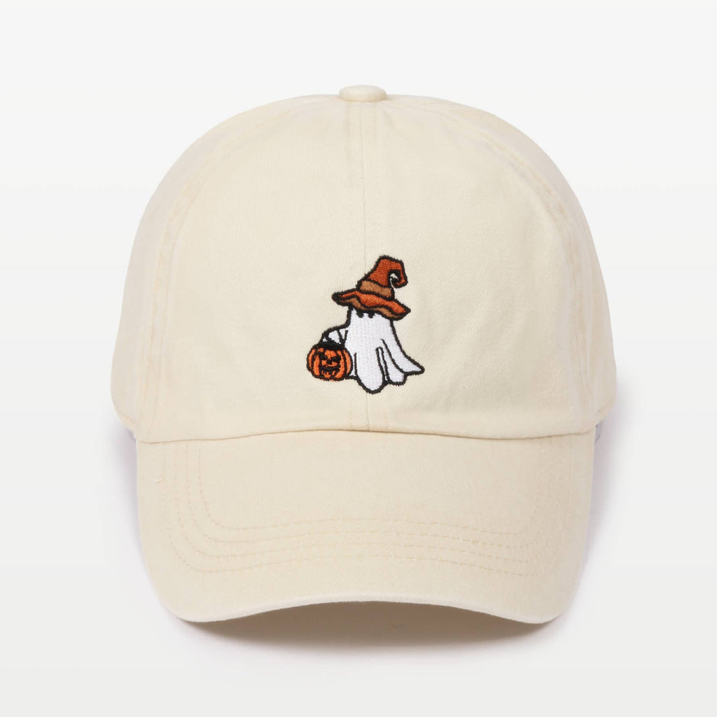 Off-white baseball cap featuring a small embroidered Halloween graphic of a ghost in a witch hat holding a pumpkin on the front