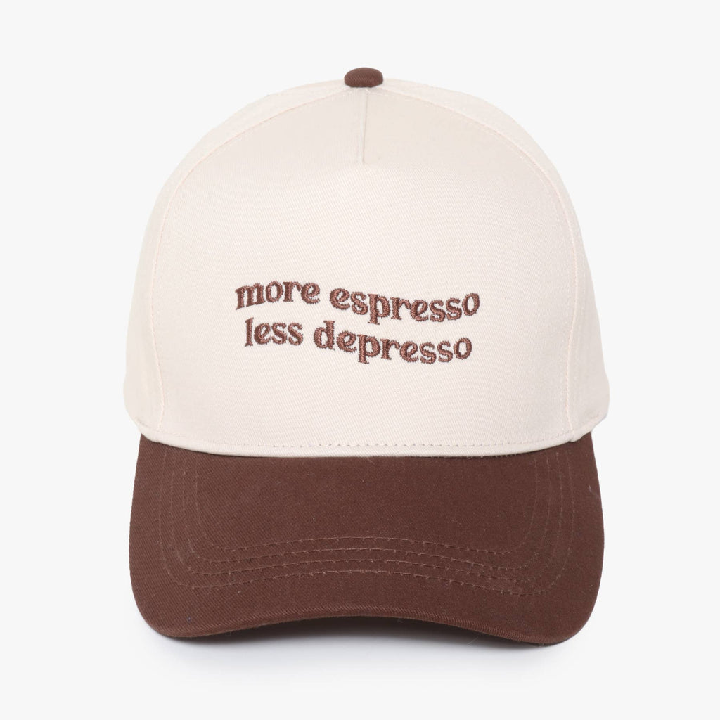 A two-tone baseball cap with an off-white crown and a brown visor, featuring the embroidered text 'more espresso less depresso' in brown on the front against a plain background