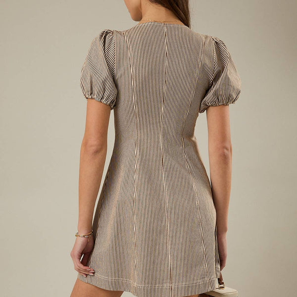 Woman wearing a beige and brown vertically striped mini dress with puff sleeves, a V-neckline, and a front "O" shaped zipper
