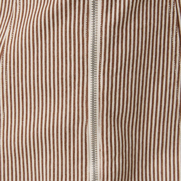 Close-up of a beige and brown vertically striped fabric with a central silver zipper