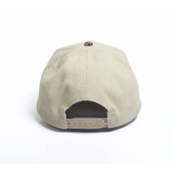 A baseball cap with an off-white crown and a brown, beige, and black houndstooth patterned visor. It features an adjustable sizer 