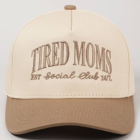 Beige and tan cap with 'Tired Moms EST Social Club 24/7' text on a plain background